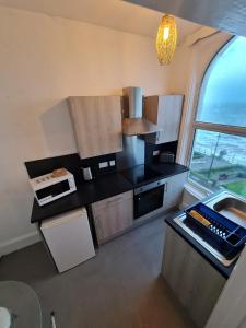 an overhead view of a kitchen with a large window at Farina No7, Sea view studio sleeping 2 guests in Bridlington +1 photo