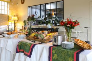 a table with a basket of bread and other food at La Chartreuse du Bignac - Teritoria in Saint-Nexans