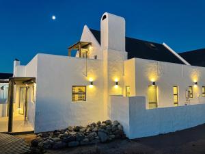 a white building with lights on it at night at Magical Mongoose in Jacobs Bay