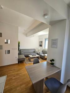 a living room with a couch and a table at EApartment in Skopje