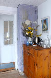 a room with a wooden cabinet with flowers on it at Rosenhøj Bed and Breakfast in Svendborg