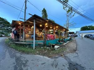 a small building with lights on the side of a street at Teresek View Motel in Kuala Tahan +10 photos