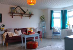 a living room with a couch and a table at Rosenhøj in Svendborg +25 photos