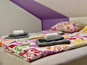 two beds with towels and pillows on top of them at Aria apartment in Mošnje