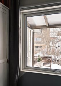 a window with a potted plant in a room at Luxury Mountain Apt with Sauna in Narvik