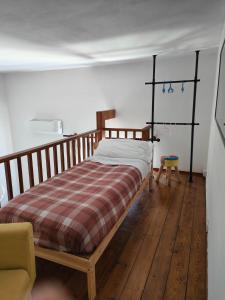 a bedroom with a wooden bed with a plaid blanket at Sunny Flat - SELF Apartments in Cefalù