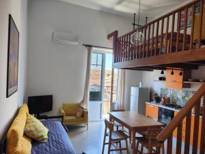 a living room with a table and a dining room at Sunny Flat - SELF Apartments in Cefalù