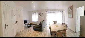 a living room with a table and a couch at La petite maison in Monthermé