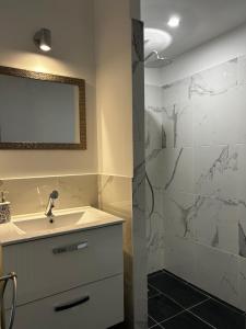 a bathroom with a sink and a shower at la porte medievale in Carcassonne +20 photos