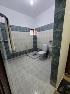 a bathroom with a toilet and a shower stall at Hotel Capital one in Karachi