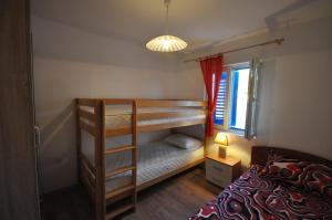 a bedroom with two bunk beds and a window at Holidayhome Florecka in Utjeha
