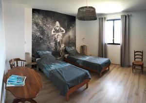a living room with two beds and a table at Le Mas du 1934 in Lorgues