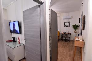 a door leading into a room with a table at Antoine Apartment in Néa Péramos