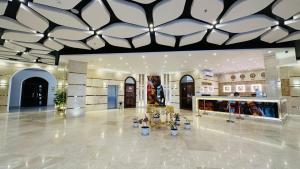 a lobby with a building with a large ceiling at Badr Hotel & Resort El Kharga in Al Khārijah