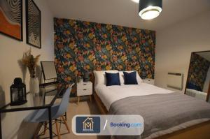 a bedroom with a bed with a large floral wallpaper at LGI Stunning 1 Bedroom Apartment By Movida Property Group Short Lets & Serviced Accommodation in Leeds