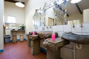 a bathroom with two sinks and a large mirror at Coffee Shack Adventure Backpackers & Self-Catering in Coffee Bay