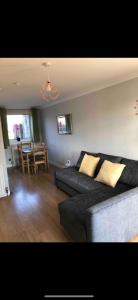 a living room with a couch and a table at Dunfermline Home with Free Parking Near Amazon & M90 in Dunfermline