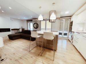 a kitchen and living room with a table and chairs at New Apartament close to IFEMA-AEROPUERTO in Madrid +10 photos