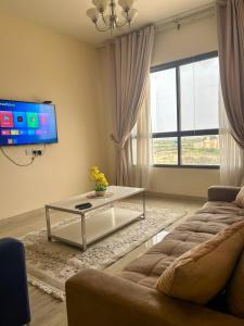 a living room with a couch and a table at SIRA apartment 1 in Muscat