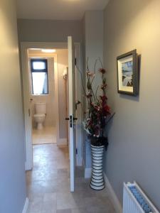 a hallway with a vase with flowers in it at Johnny B's B&B in Ballybofey