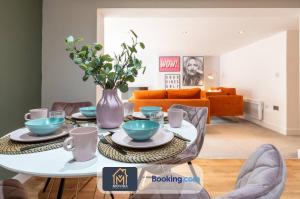 a living room with a table with a vase at Stylish Two Bed Town Centre Apartment By Movida Property Group Short Lets & Serviced Accommodation With Parking in Harrogate