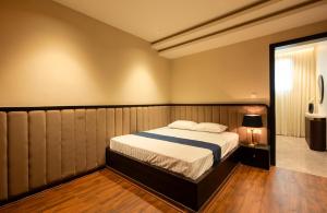 a bedroom with a bed in a room at Oak 5 in Bangalore
