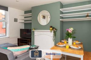 a living room with a table and a fireplace at The Hyde Away Chic Urban Two Bedroom House By Movida Property Group Short Lets & Serviced Accommodation in Headingley
