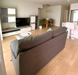 a living room with a gray couch and a table at Apartamento Abades Playa & Relax in Abades