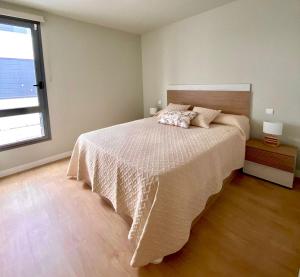 a bedroom with a large bed and a window at Apartamento Abades Playa & Relax in Abades