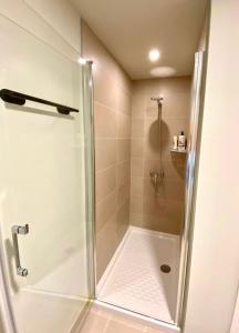 a shower with a glass door in a bathroom at Apartamento Abades Playa & Relax in Abades
