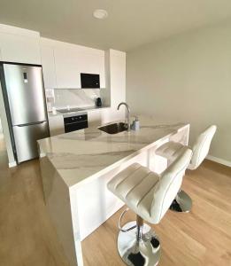 a kitchen with a counter with a sink and a chair at Apartamento Abades Playa & Relax in Abades