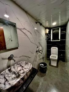 a bathroom with a sink and a toilet at Imagine Love in Lonavala