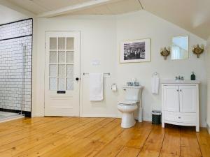 a white bathroom with a toilet and a sink at Maison TURCOT in Saint-Hyacinthe +29 photos