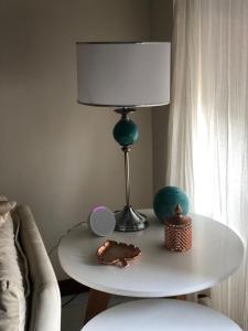 a table with a lamp and two cakes on it at Arena in Mar del Plata