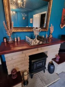 a living room with a fireplace and a mirror at Apartment 9 3/4 in Watford