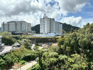 a city with two tall buildings and trees at Themework Homestay@Cameron Highlands in Cameron Highlands