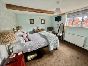 a bedroom with a bed and a window at Eagle House - award winning luxury B&B and Apartment in Eccleshall