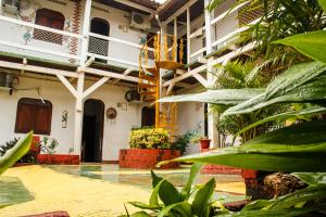 a courtyard of a building with plants at Hotel Tropicalia in Canoa Quebrada
