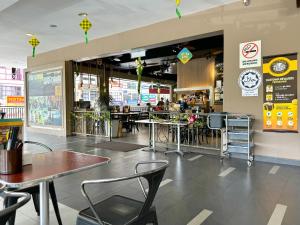 a restaurant with tables and chairs in a store at Themework Homestay@Cameron Highlands in Cameron Highlands
