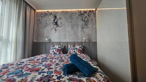 a bedroom with a bed with a blue pillow on it at Apartament Elegance, Metro, free parking in Warsaw