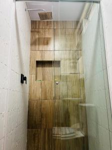 a shower with a glass door in a bathroom at Apartamento céntrico Frida's todo nuevo in Tarija