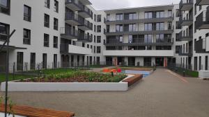 an apartment building with benches in a courtyard at Apartament Elegance, Metro, free parking in Warsaw