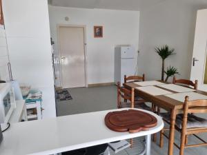 - une cuisine avec une table et un chapeau dans l'établissement Spacieux Appartement RDC tout confort, à Lorient