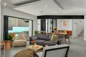a living room with a couch and a table at Neighbourgood 1st Crescent Camps Bay in Cape Town