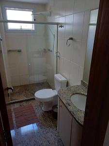 a bathroom with a toilet and a sink at Casa do Vô Luiz in Vila Velha