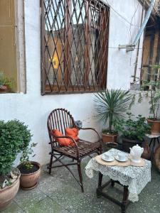 a chair and a table on a patio with plants at Apartment Sololaki in Tbilisi City