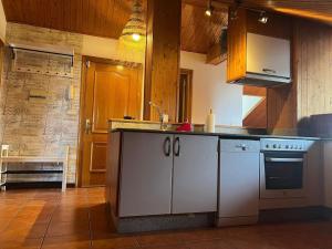 a kitchen with a sink and a stove at El Pedregal - Playa de Miño in Miño