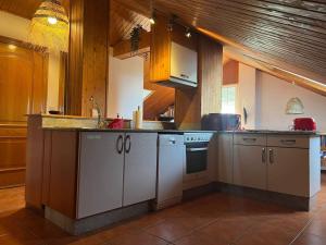 a kitchen with white cabinets and a counter top at El Pedregal - Playa de Miño in Miño
