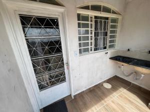 an empty room with a door and a window at Hospedaria cmc unidade 05 com estacionamento in Brasilia