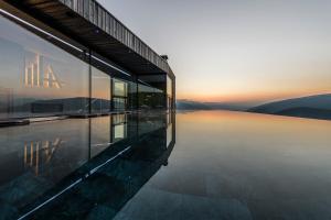 a building with a view of a body of water at Hotel Ambet in Maranza